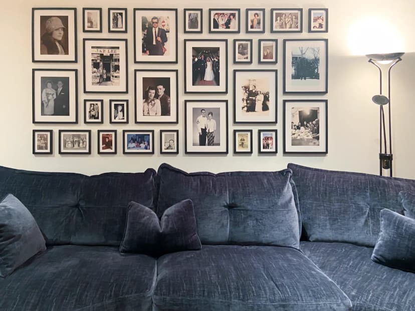 Heritage [gallery wall](/en-gb/photo-gallery-walls) with family photos spanning from 1889-2005, showing portraits from England, Italy, America and Denmark