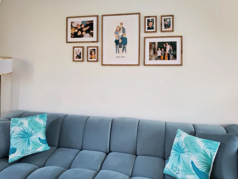 Family gallery wall with wooden frames above a couch